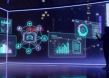 A man in front of a high-tech display featuring various digital icons, representing a futuristic technological environment.